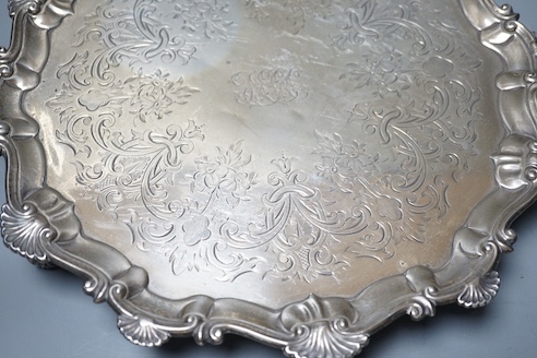 A late George II silver salver, with later engraved decoration, Ebenezer Coker, London, 1758, diameter 32cm, 25.5oz.